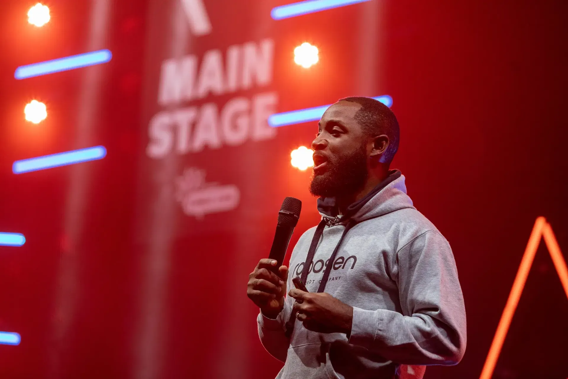 Justice Bartels speaking with a microphone on stage